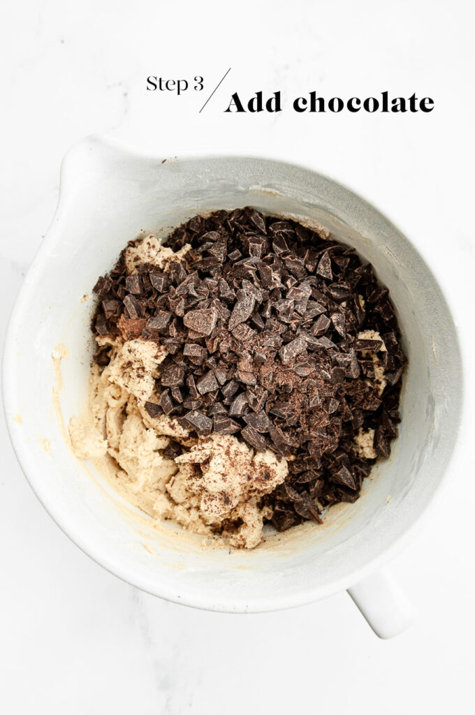 cookie dough with chocolate chips in white mixing bowl