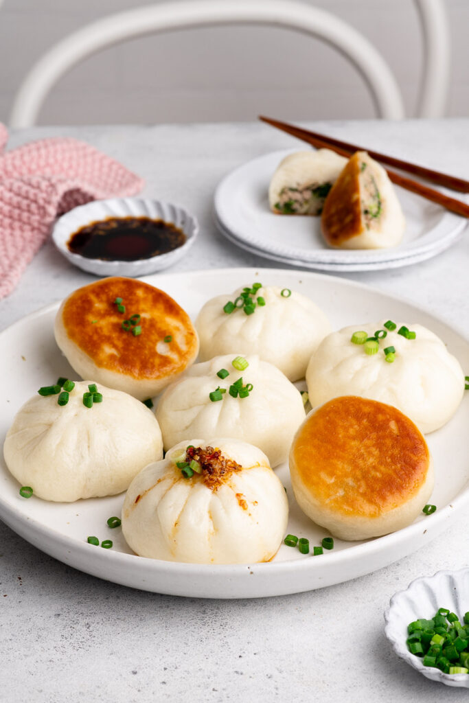 pan-fried pork buns on plate drizzled with chilli oil