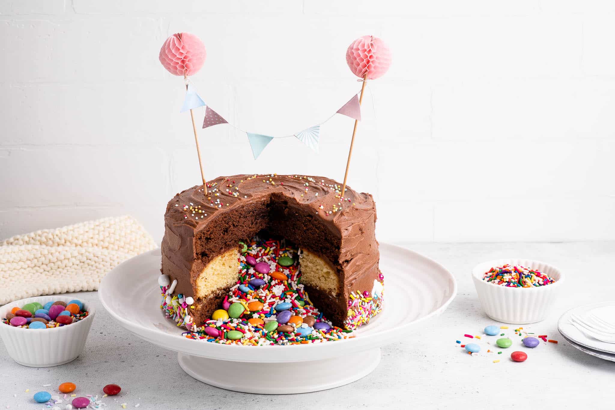 chocolate piñata cake filled with candies and sprinkles
