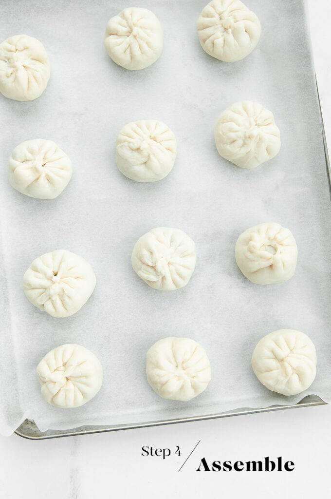 pan-fried bao buns on baking sheet