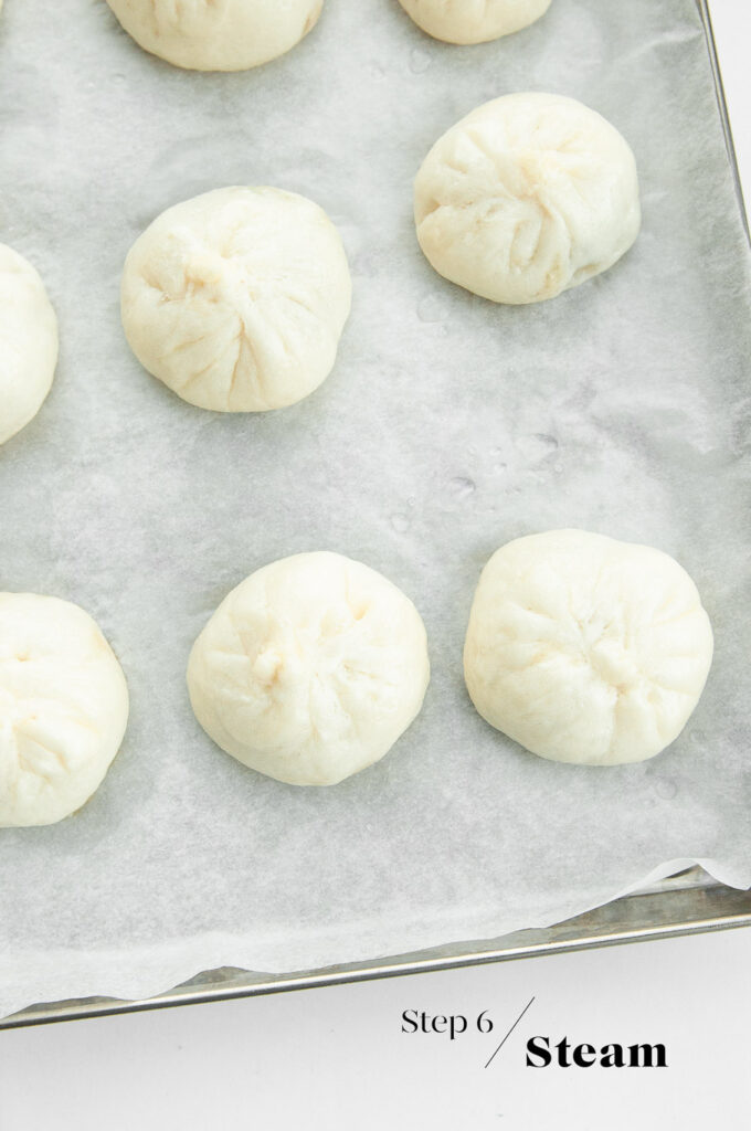 steamed bao buns on baking sheet