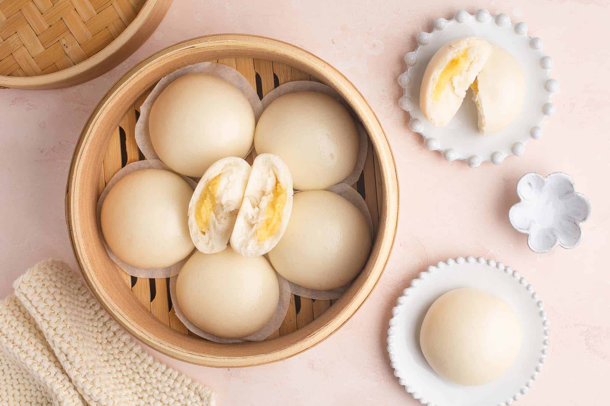 chinese steamed custard buns on pink table