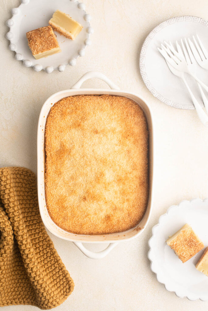 butter mochi cake in ceramic baking dish with coconut