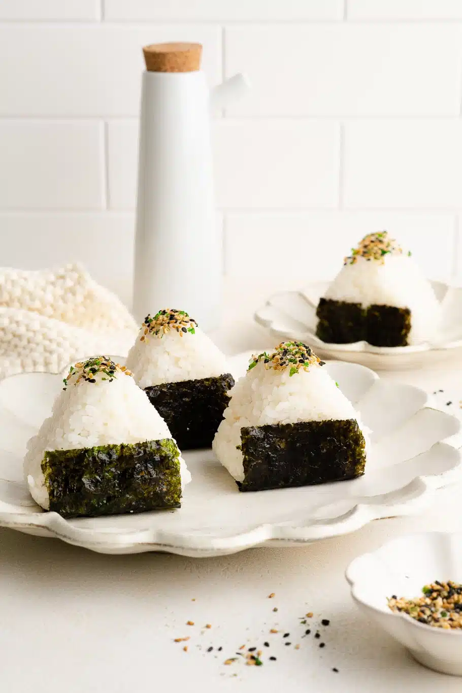 onigiri wrapped in nori on white plates