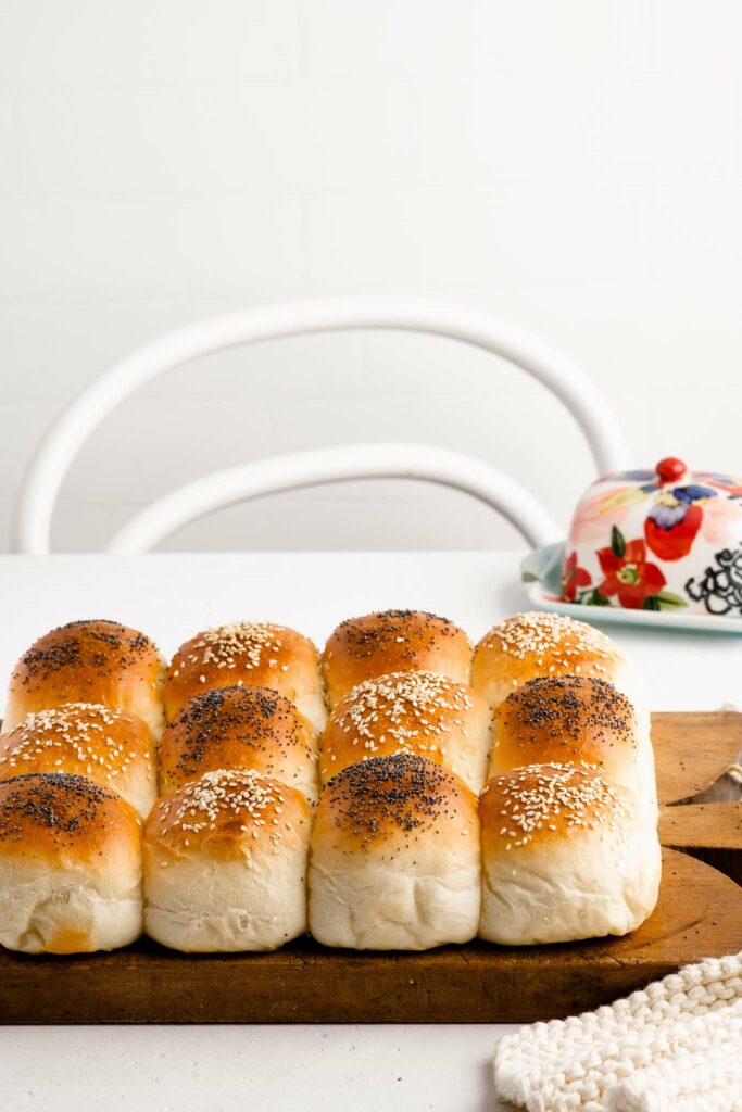 soft white bread rolls on wooden board