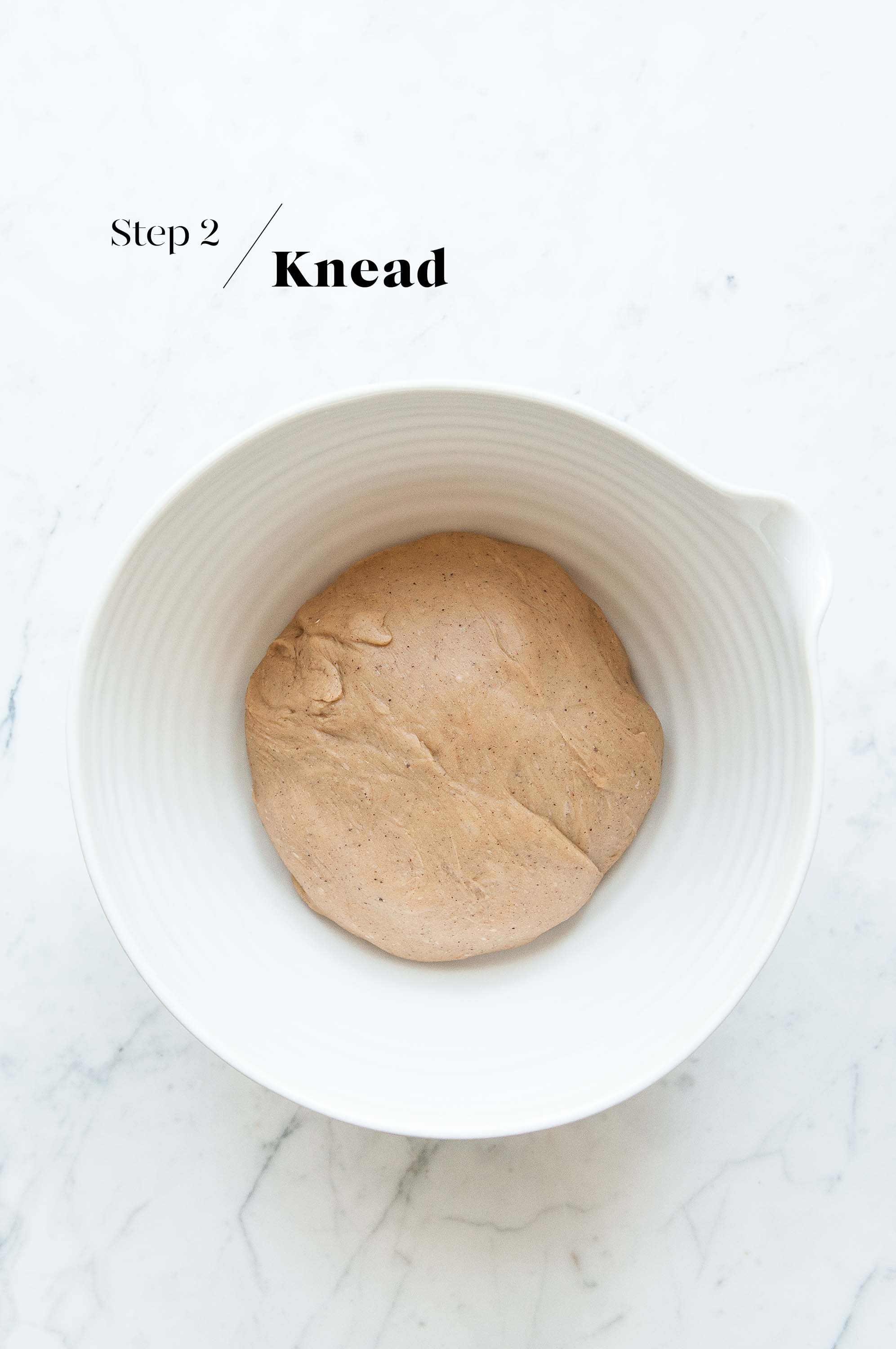 dough for hot cross bunnies in white mixing bowl