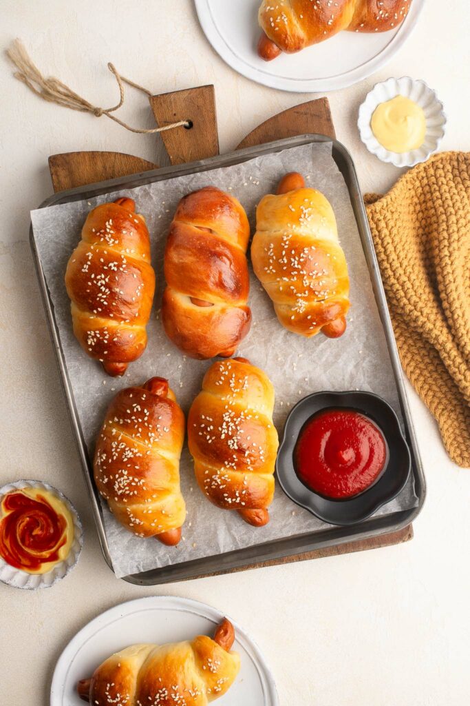 chinese hot dog buns on baking tray with ketchup