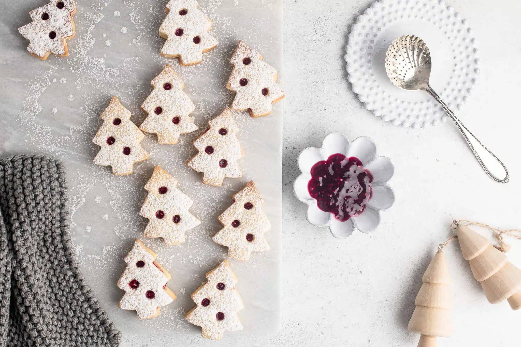 christmas tree linzer cookies on marble table