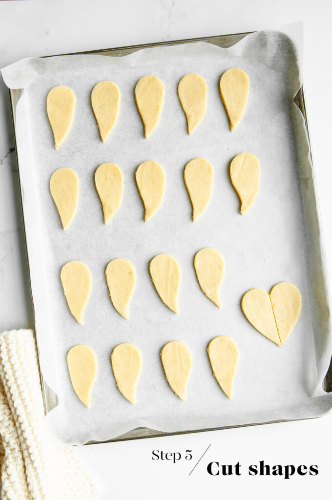 making ghost linzer cookies on baking tray