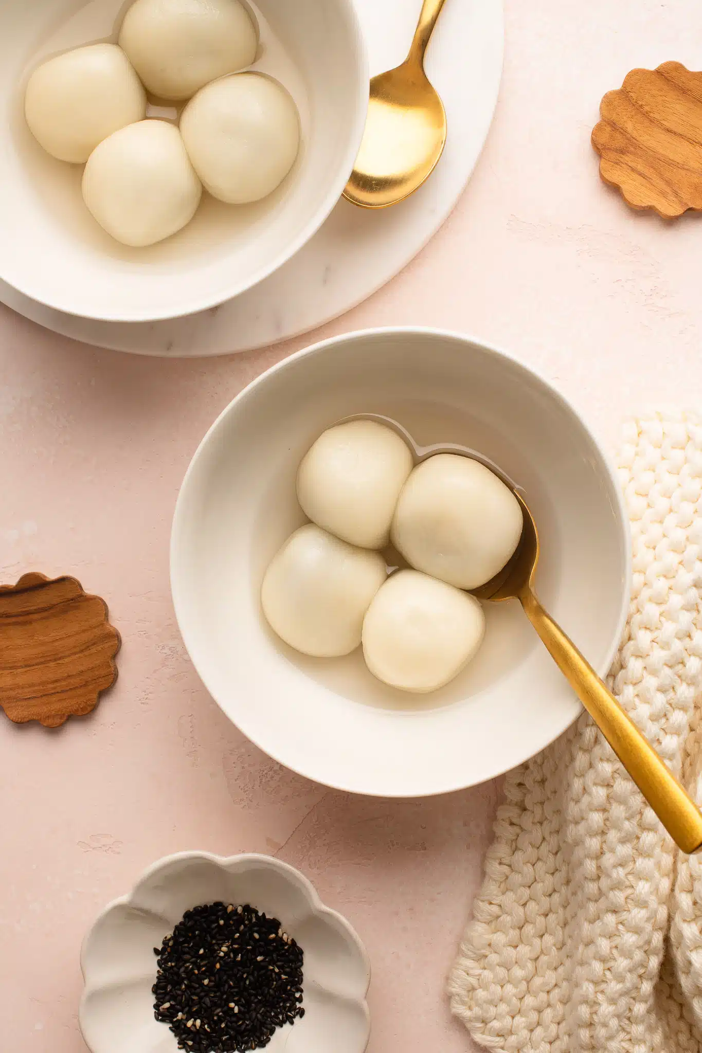 tang yuan in white bowls with teaspoon