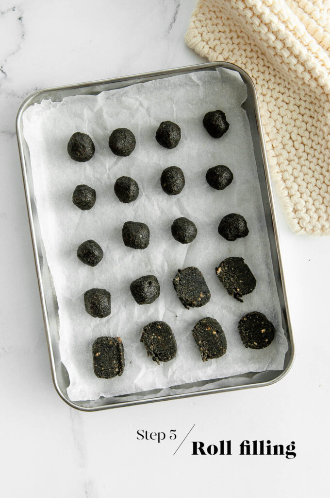 black sesame paste rolled into balls on baking tray