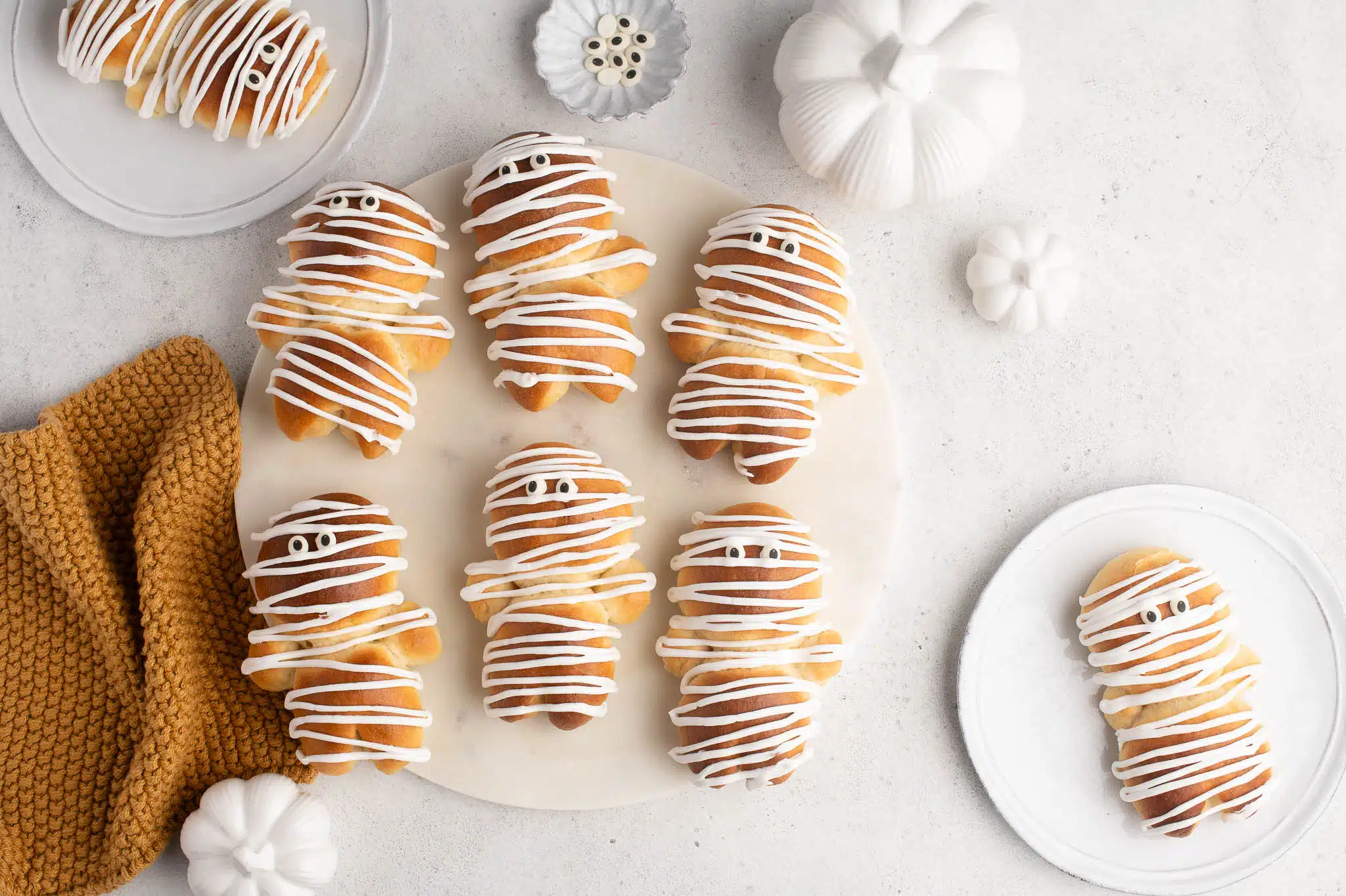 decorated halloween brioche mummies with royal icing and candy eyes