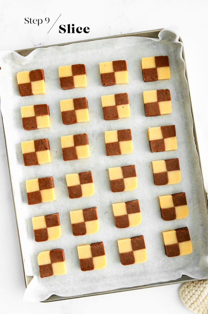 Sliced checkerboard cookies on baking tray before going into oven