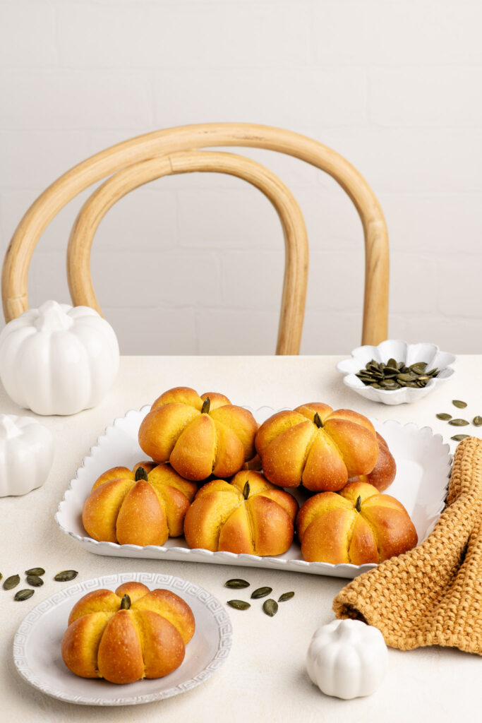 pumpkin bread rolls with pumpkin seeds on table