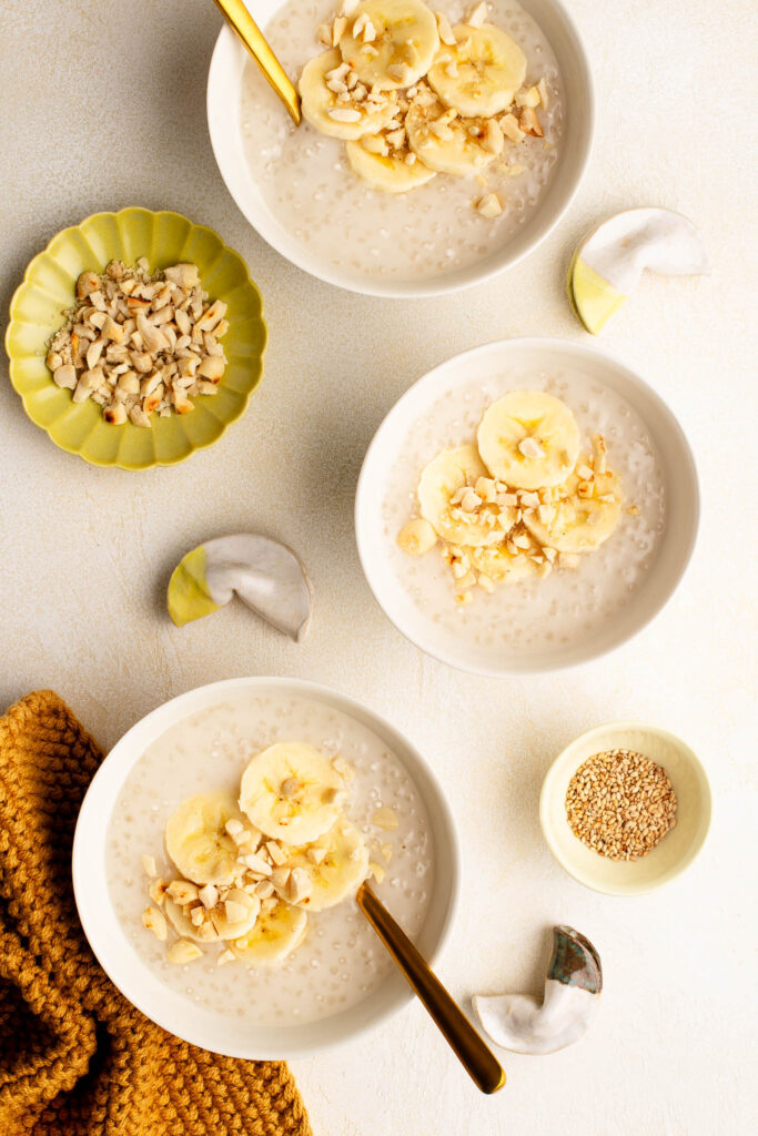 vietnamese banana coconut tapioca pudding with crushed peanuts in dessert bowls