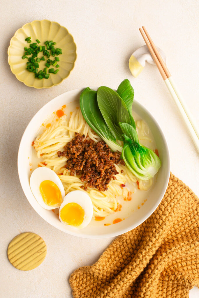 tantanmen ramen with bok choy and soft boiled eggs in bowl