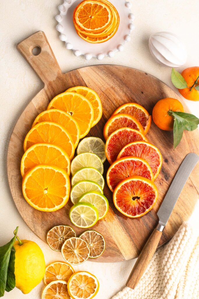 sliced citrus fruits on wooden board