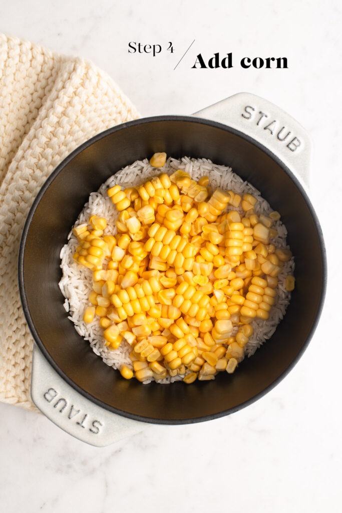 rinsed rice with corn kernels in pot