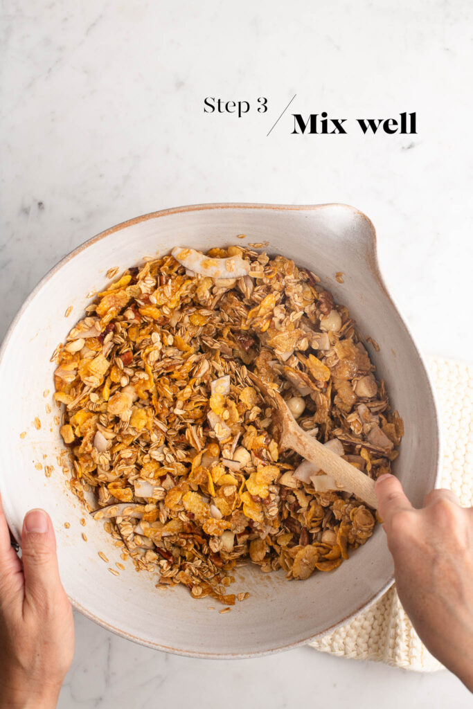 mixing granola in white mixing bowl