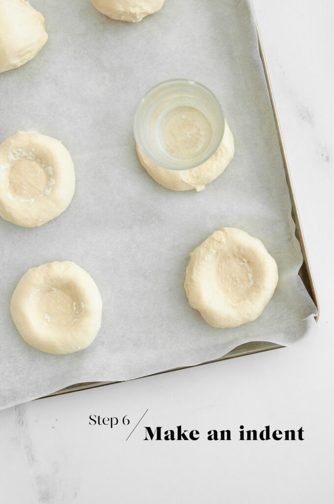 shaping bread dough on baking tray