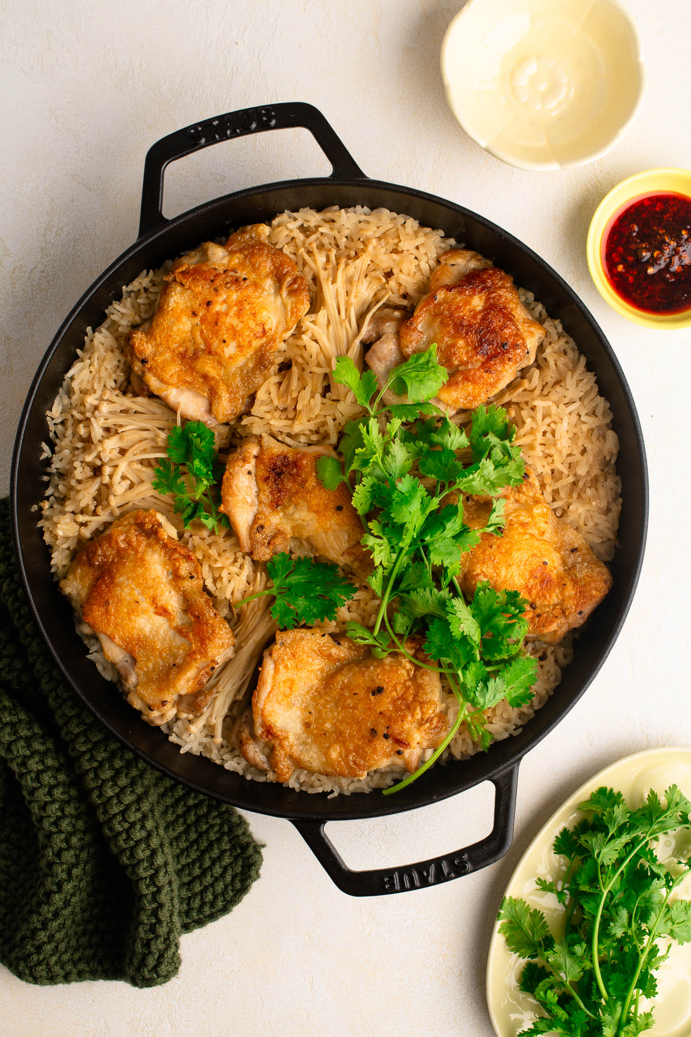one pan chicken and rice in staub cast iron pan with herbs