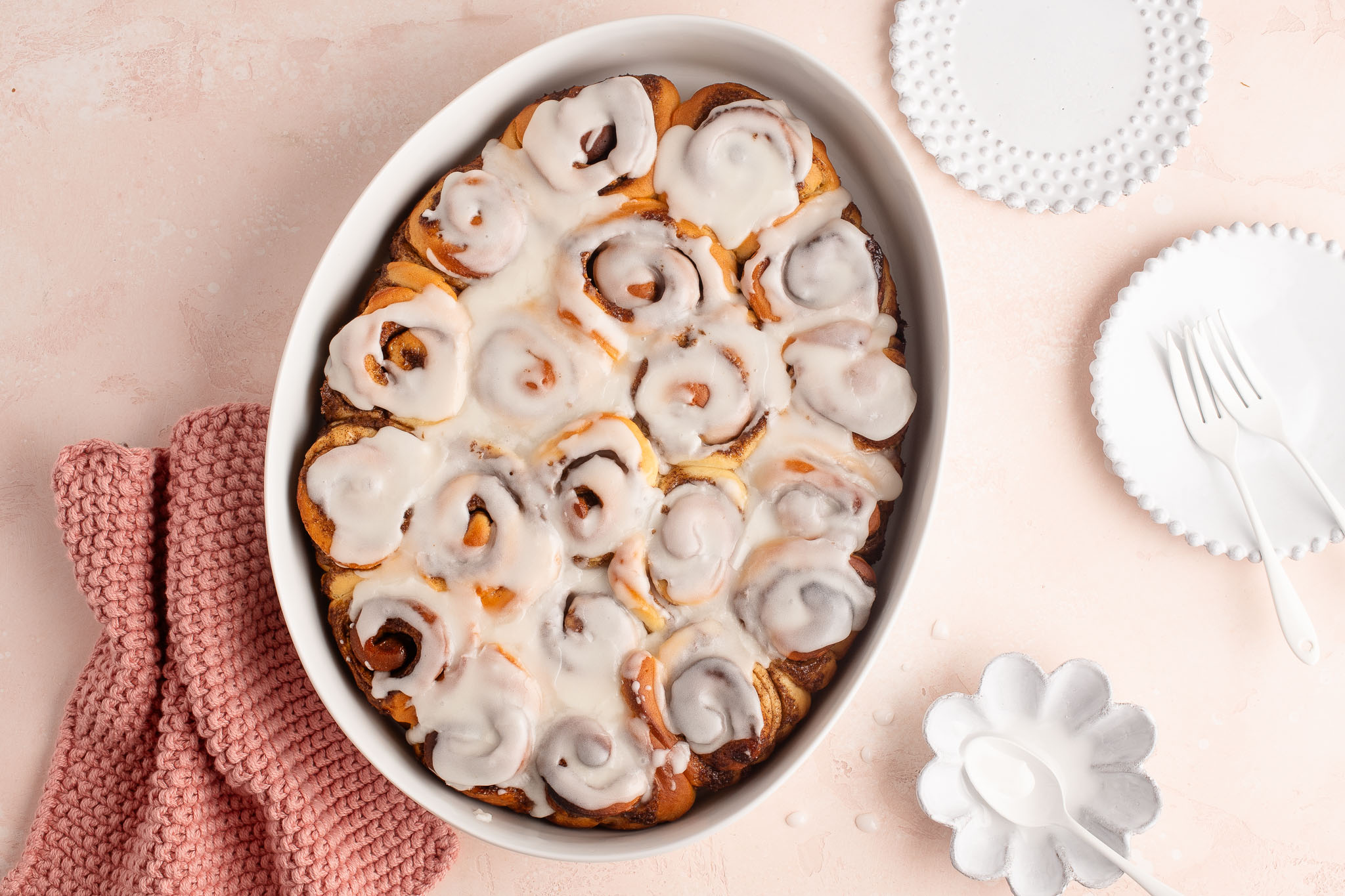 mini cinnamon rolls with icing in white dish