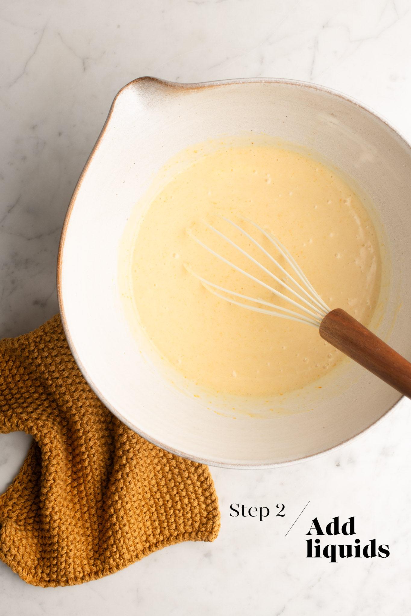 adding liquids to mochi batter in white mixing bowl