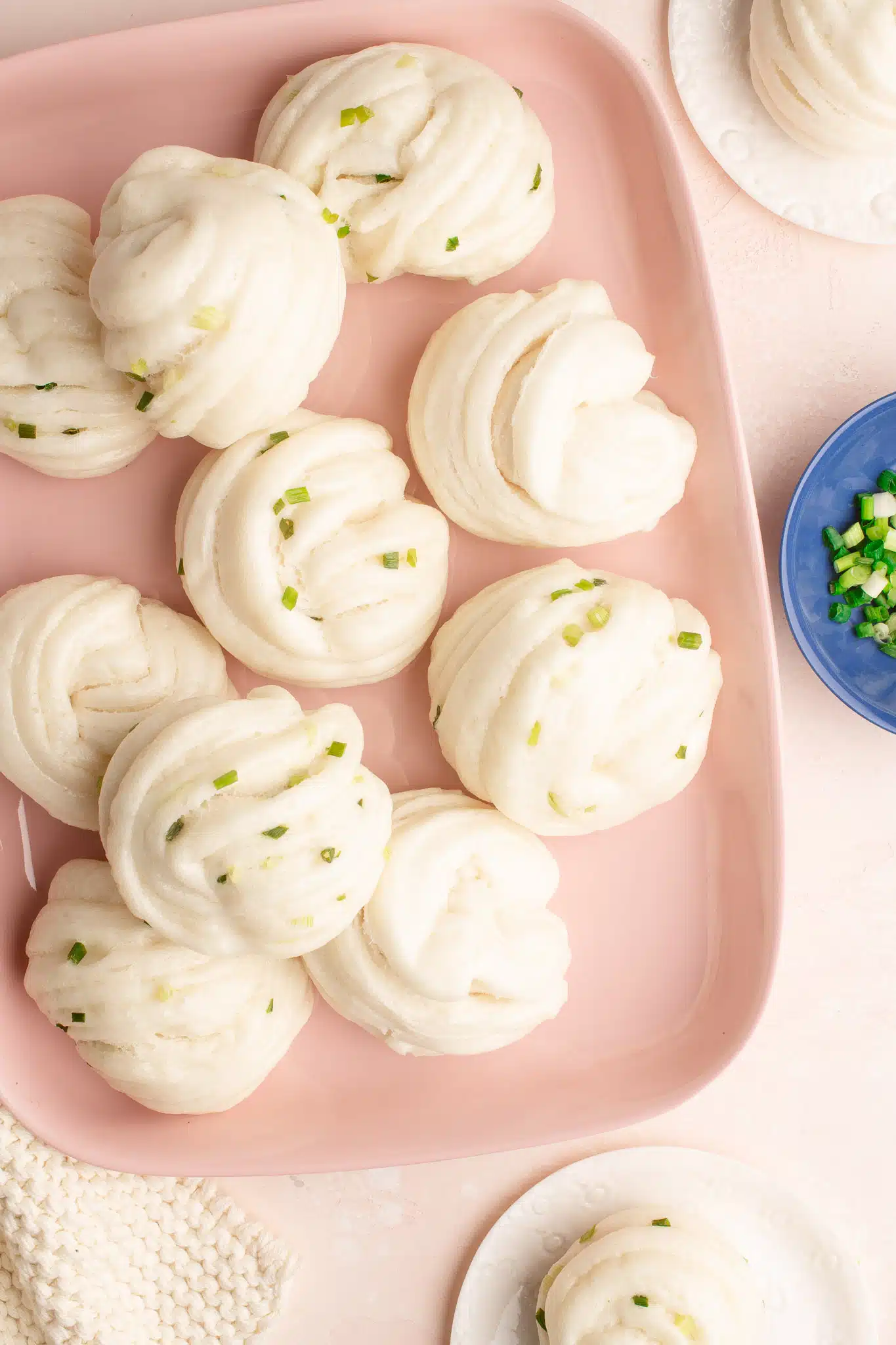 spring onion flower buns on pink plate