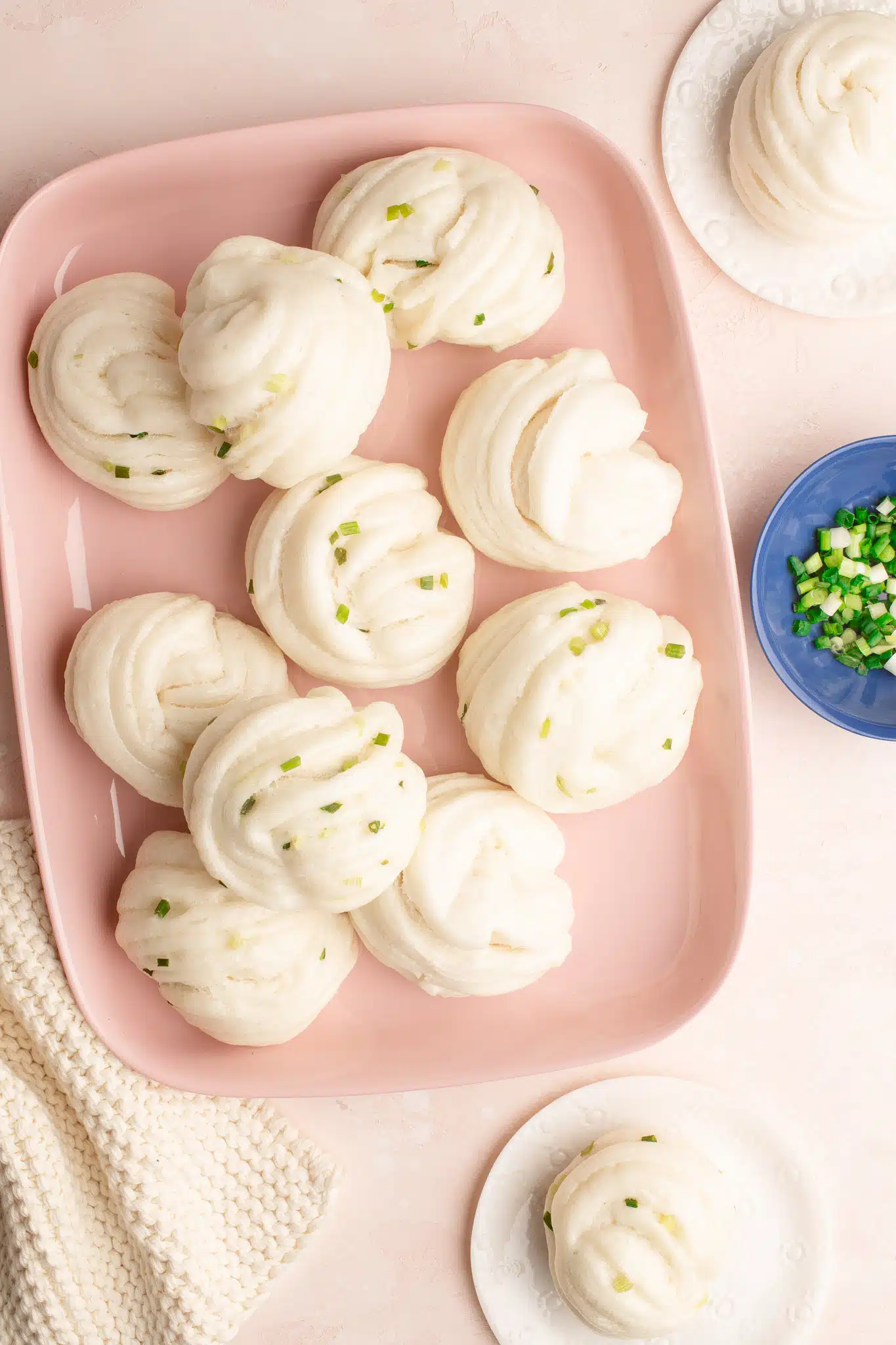 scallion flower buns on pink plate