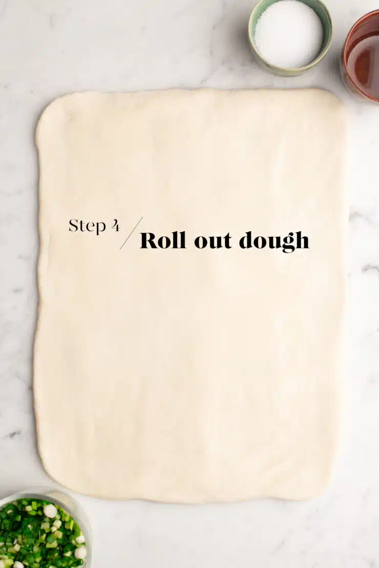 rolling out bao bun dough to make flower buns