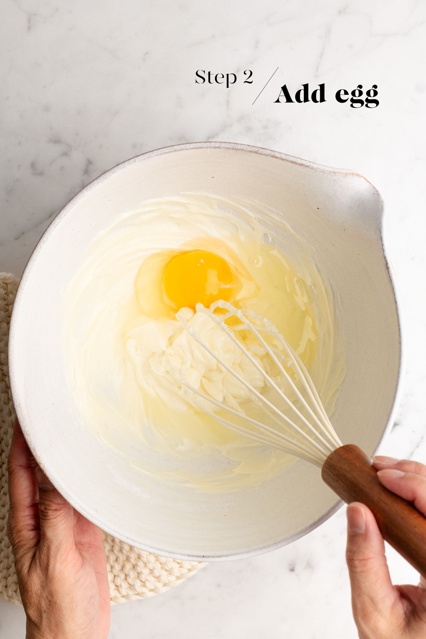 eggs with cream cheese in mixing bowl with whisk