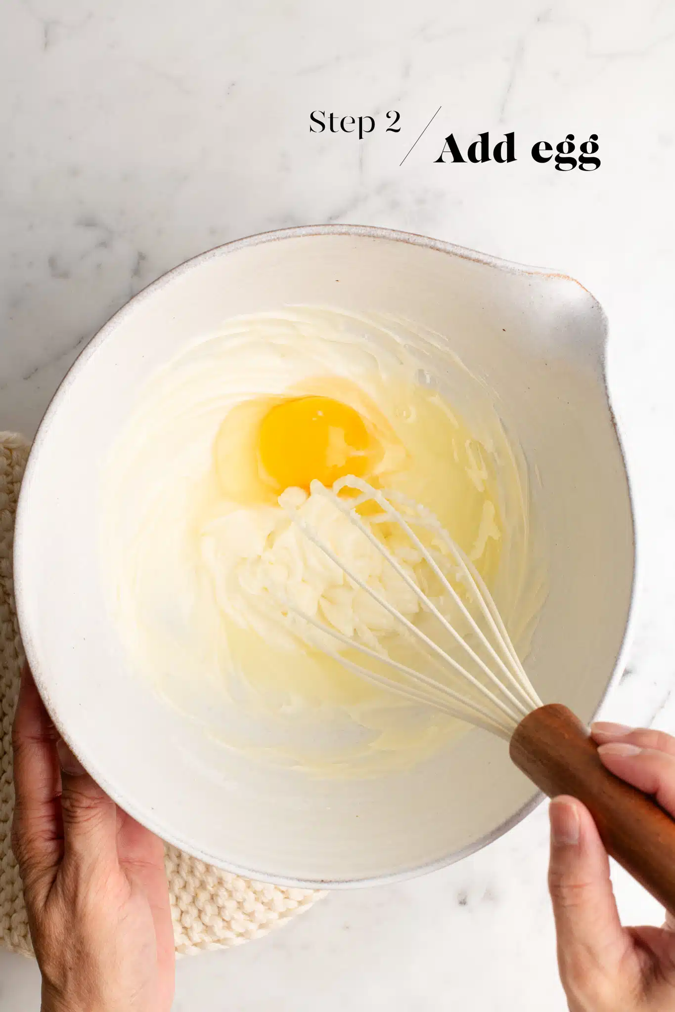 eggs with cream cheese in mixing bowl with whisk