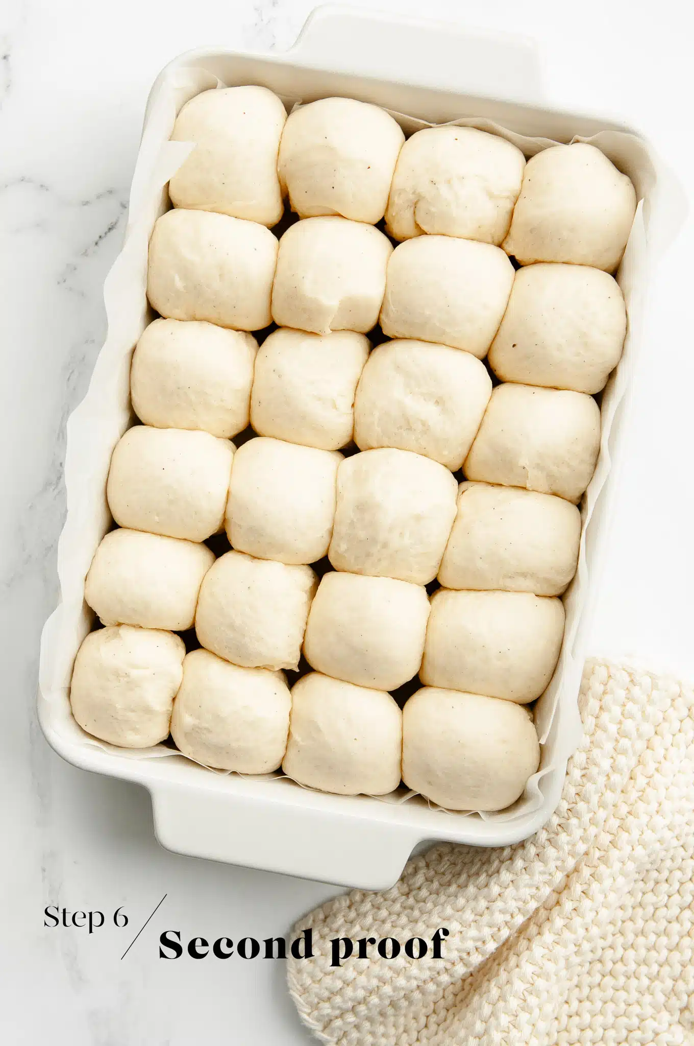 risen bread dough in white baking dish