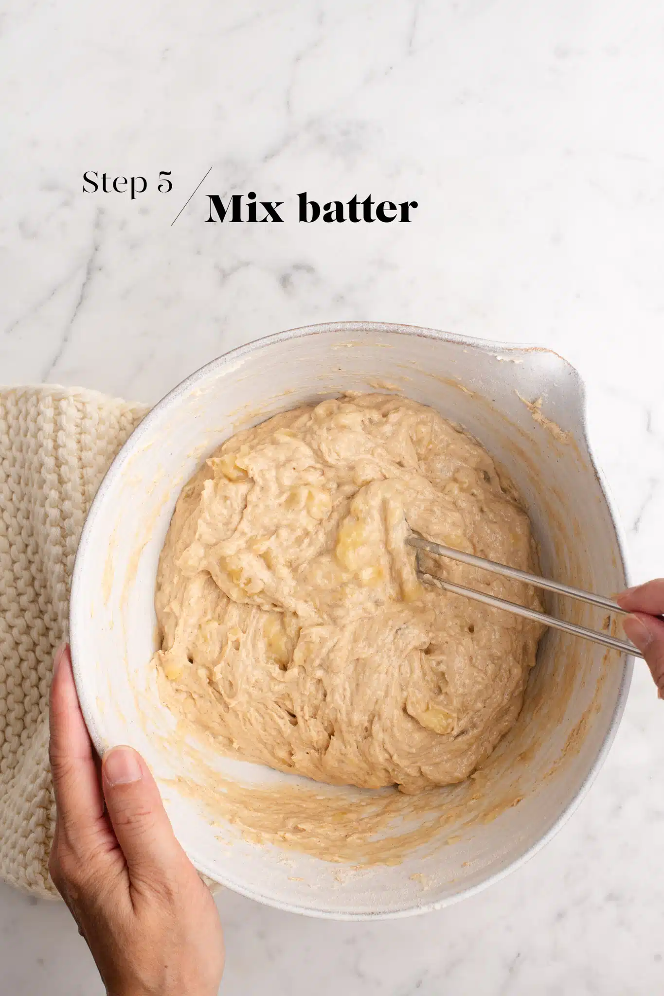 batter for banana bread in white mixing bowl