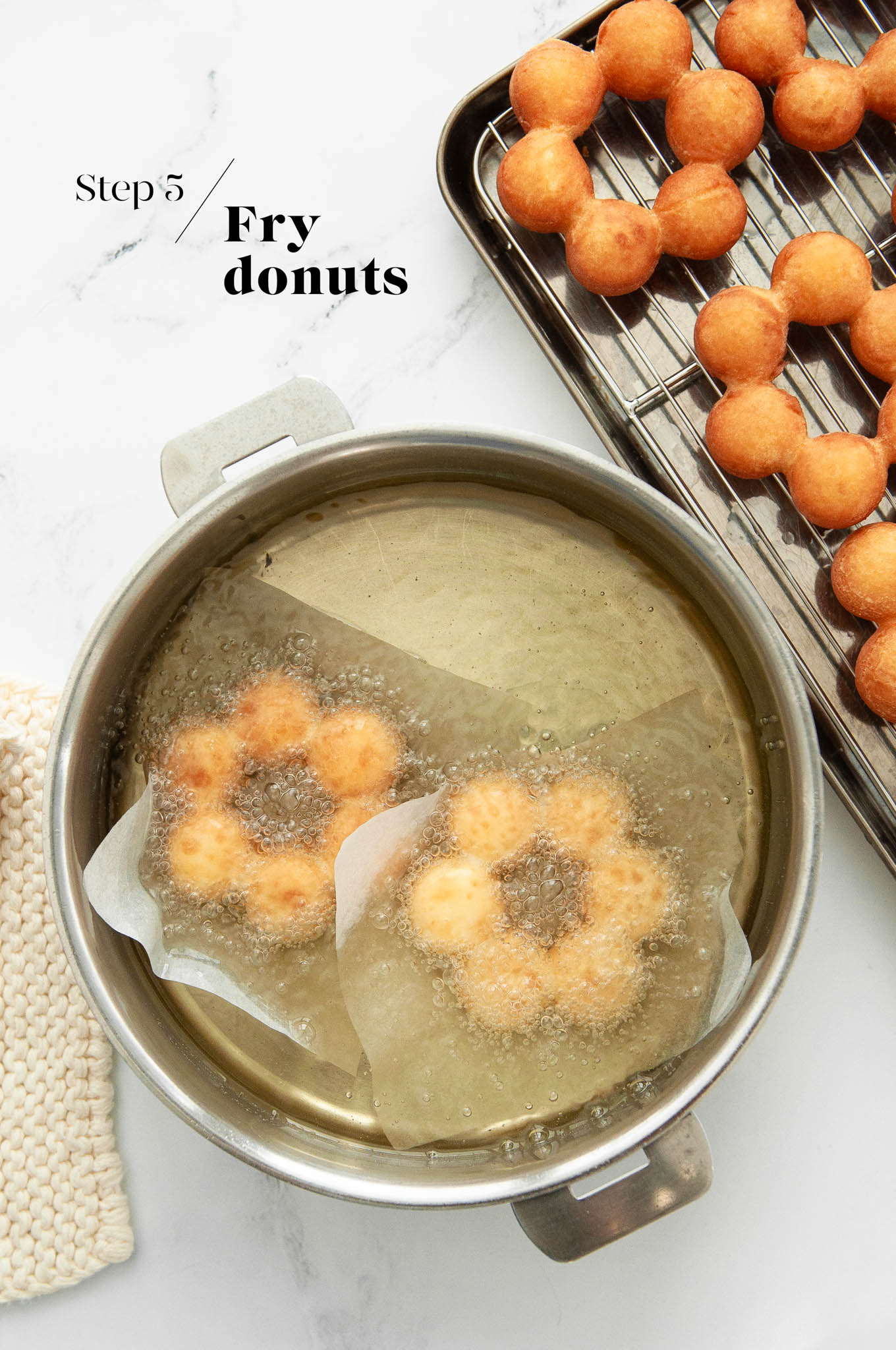 frying mochi donuts in pan of oil