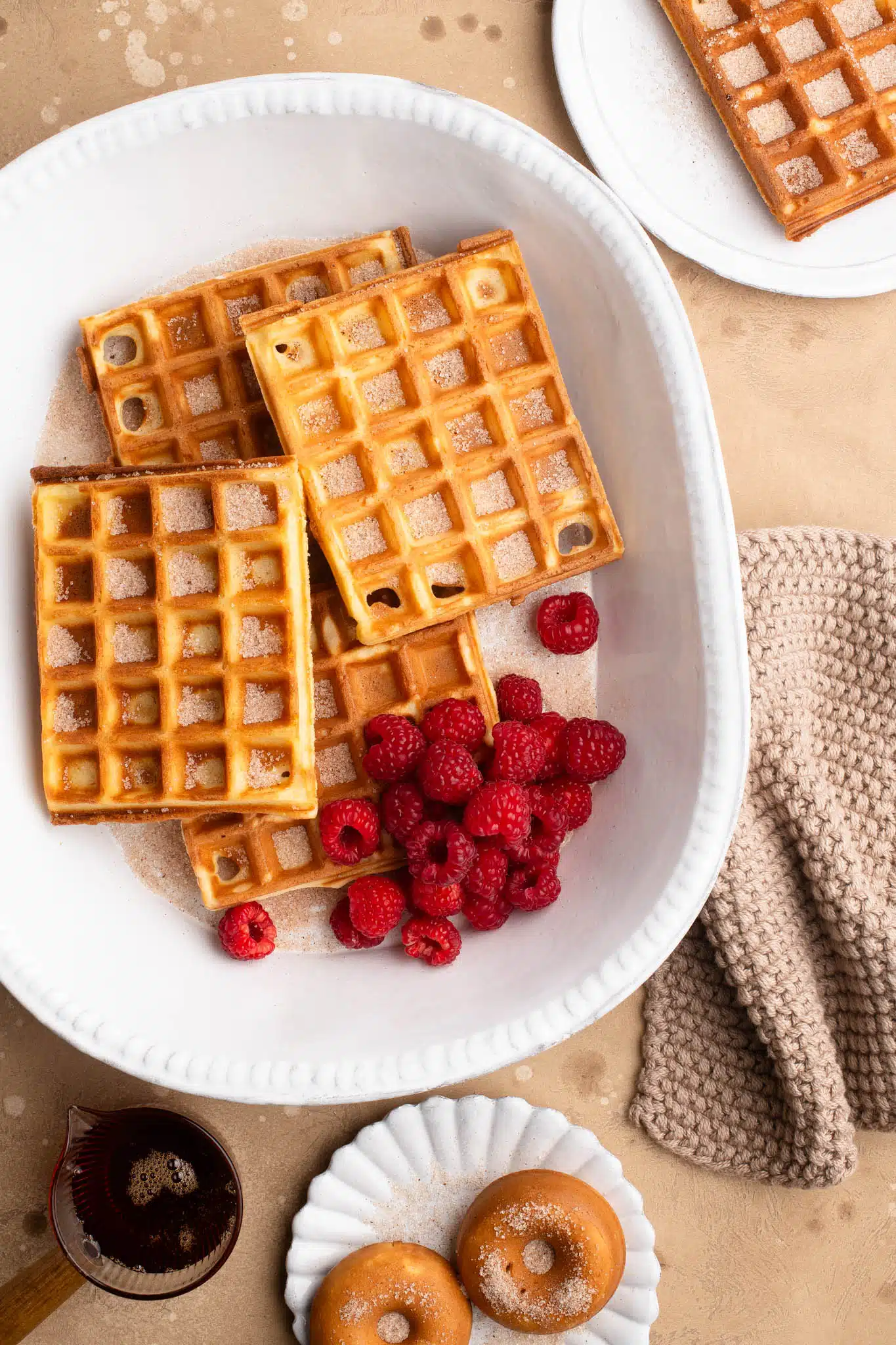 mochi waffles sprinkled with cinnamon sugar on white plate