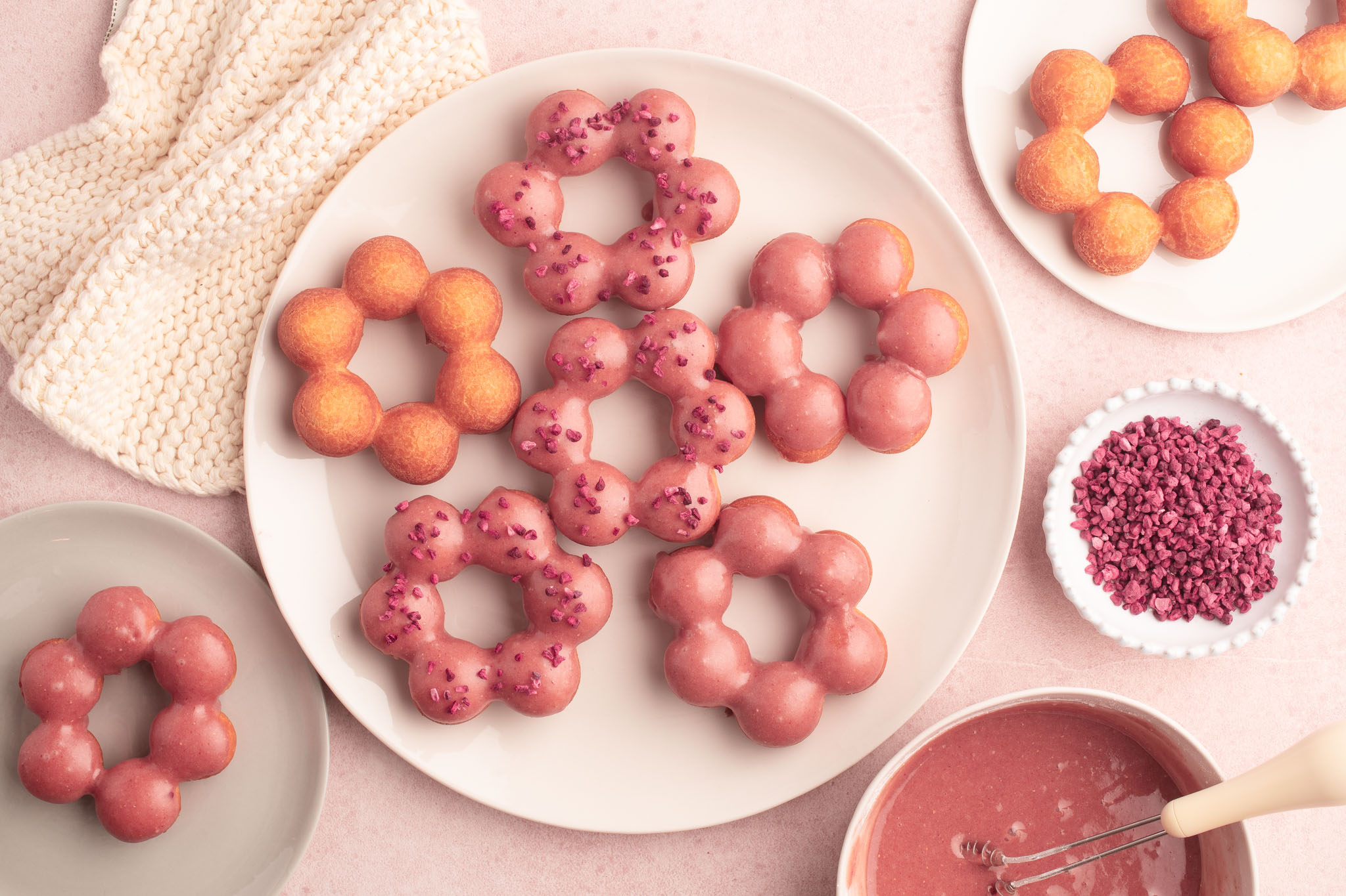 mochi donuts with strawberry glaze on large plate